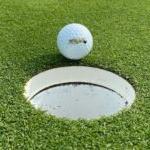 BHC Braves golf ball on edge of cup on the green
